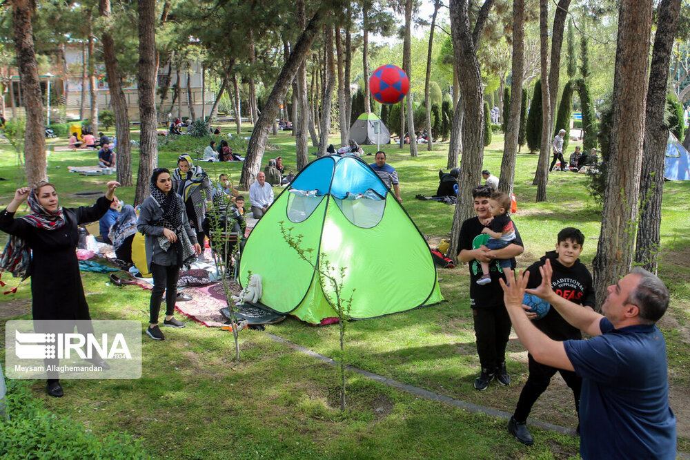 خانواده ایرانی در حال بازی والیبال در روز طبیعت