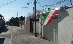 پرچم ایران بر سر در چند خانه در یکی از محله‌های تهران